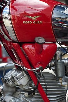 the front end of a red motorcycle parked in a parking lot