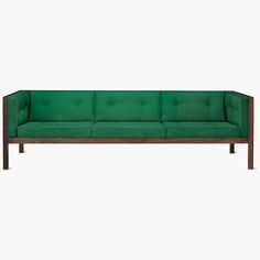 a green couch sitting on top of a wooden frame