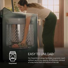 a woman is cleaning the inside of an appliance