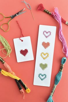 some crafting supplies are laid out on a pink surface