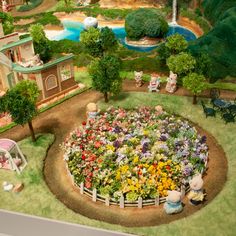 a fake garden with flowers and animals in it