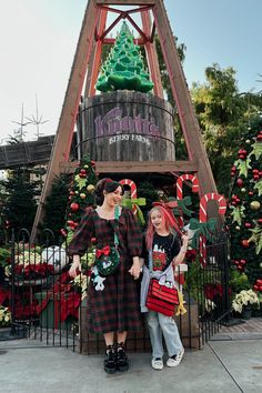 two women standing next to each other in front of a christmas tree at knotia