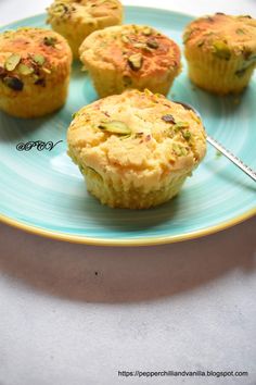 several small muffins on a blue plate with a spoon