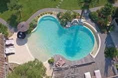 an aerial view of a swimming pool surrounded by palm trees