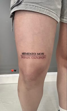 a woman's leg with the words, mementoo mori written on it