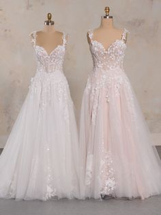 two wedding dresses on mannequins in front of a wall