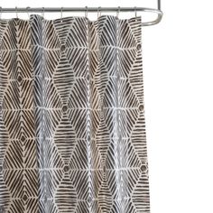 a shower curtain with an abstract pattern on the bottom and side, hanging from a metal rod