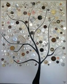 a tree made out of buttons on a white wall with the words love written in it