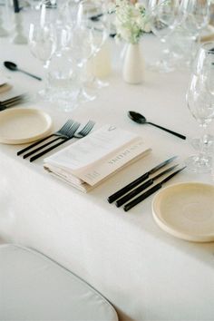 the table is set with black and white place settings