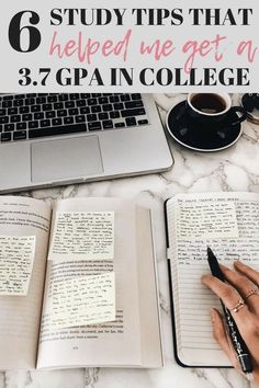 a woman's hand writing on an open notebook next to a laptop and coffee cup