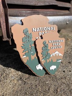 the national park service sign is shown in front of an old truck with trees and mountains on it