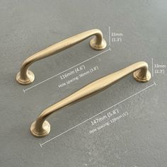 two brass handles with measurements for each handle