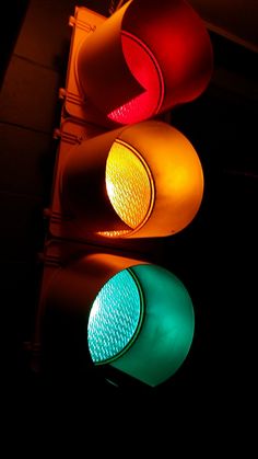 two traffic lights that are red, green and yellow