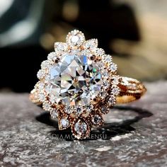 a diamond ring sitting on top of a rock