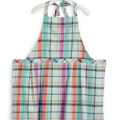 two aprons are hanging on the clothes hanger, one has an orange and green plaid