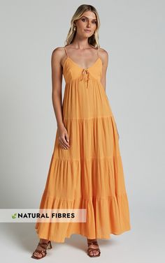 Get ready to turn heads in the Chila Maxi Dress! This stunning papaya orange dress features a strappy tie-front design and a low back for a flirty touch. The tiered A-line silhouette adds movement and flow, while the sleeveless style keeps you cool during those warm summer days. Made from soft cotton fabric, this casual dress is both comfortable and stylish. Whether you're attending a brunch with friends or going out for date night, the Chila Maxi Dress is bound to make you feel confident and be Strappy Ruffle Dresses For Beach, Strappy Ruffled Dresses For Beach, Strappy Ruffled Beach Dresses, Beach Dresses With Adjustable Straps And Tiered Design, Beach Dresses With Adjustable Straps And Tiered Shape, Casual Tiered Beach Dress With Adjustable Straps, Spring Beach Tiered Dress With Adjustable Straps, Summer Tiered Sundress With Tie Back, Tiered Tie Back Summer Sundress