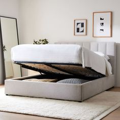 a bed with a mattress underneath it on top of a rug