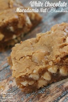 two pieces of white chocolate macadamia nut blondies on top of a wooden table