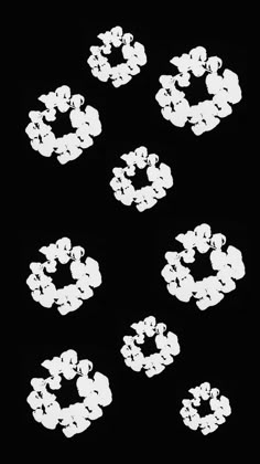 six white circles are arranged in the shape of flowers