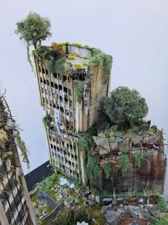 a model of a building with trees growing out of it