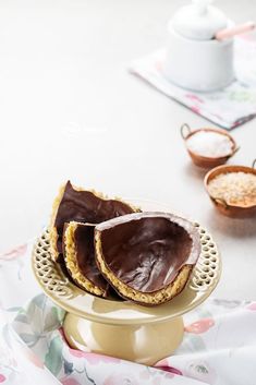 three pieces of chocolate covered cookies on a plate