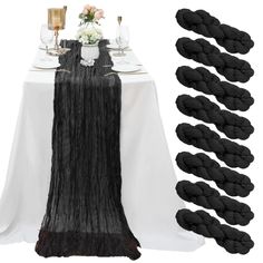 the table is set with black rope and wine glasses