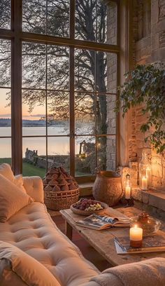 a living room filled with furniture and a fire place in front of a large window