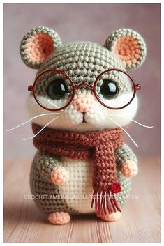 a crocheted mouse wearing glasses and a scarf