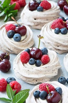 small desserts with whipped cream, berries and mint leaves