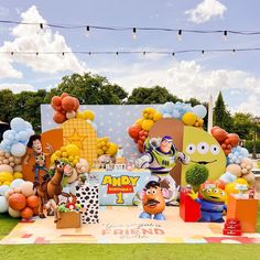 an outdoor birthday party with balloons, decorations and characters on the lawn for children's birthday