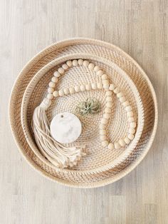 a woven basket with beads and an air plant