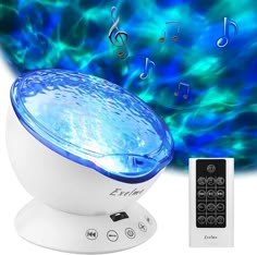 a blue and white light with music notes on it next to a remote control for the speaker