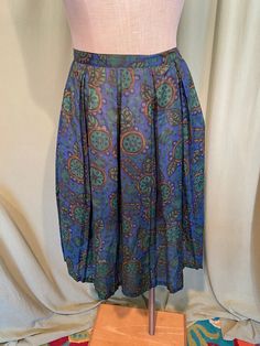 "This is a cute, vintage, 2 piece matching skirt set from early 60s. No labels or tags, appears home sewn It is a skirt and a matching middy top in a cotton blend print of mod flowers & fruit. The fabric is semi sheer. No size tag. Waist measures 26\", bust measures 36\", please see measurements below. The top is a middy top & when worn with the skirt will bare a little of your midriff. It has a fitted band bottom & the rest blouses like a small blouson. The top is semi sheer & i Vintage Pleated Mini Skirt, Retro Pleated Mini Skirt, Retro Blue Cotton Skirt, Vintage Blue Full Skirt, Retro Blue Pleated Skirt, Retro Blue Lined Skirt, Retro Blue Full Skirt, Vintage Blue Lined Skirt, Blue Lined Vintage Skirt