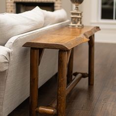 a wooden table sitting on top of a white couch