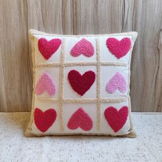 a decorative pillow with hearts on it