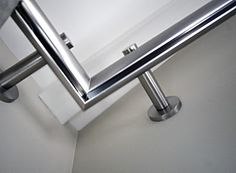 a close up of a metal rail in a bathroom with white walls and flooring