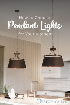 two pendant lights hanging over a kitchen island