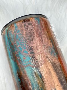 a close up of a metal can on a white background with some paint splattered