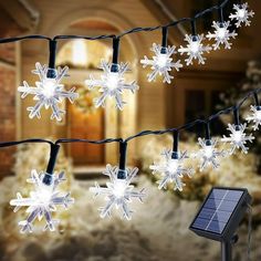 solar powered snowflake lights in front of a house