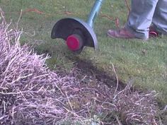 a man is using a lawn mower to cut the grass