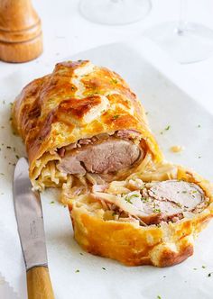 a ham and cheese pastry with a knife next to it