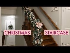 stairs decorated with christmas garland and poinsettis for the holiday season in pink