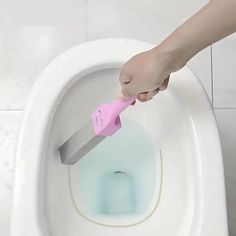 a person is using a sponge to clean a toilet