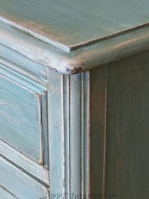 an old dresser painted in blue and silver