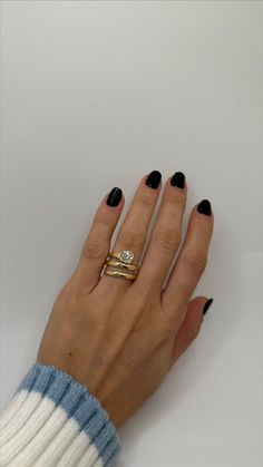 a woman's hand with two rings on it