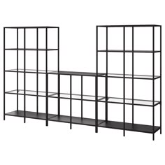 three black shelves with metal frames on each side and one shelf below them, both holding bookshelves