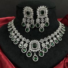 Gorgeous fine quality replica diamond and emerald green studded necklace with a white  rhodium plating and matching Earrings Item contains: Necklace and earrings AAA-quality cubic zirconia was used. Highest quality and craftsmanship Necklace Fitting is adjustable Earrings Closure: Pushback Necklace Closure: chain with Hook Hallmarked Green Diamond Jewelry, Green Hallmarked Diamond Jewelry, Traditional Green Diamond Necklace, Green Hallmarked Emerald Necklace For Wedding, Traditional Silver Emerald Anniversary Necklace, Traditional Emerald Jewelry Sets For Formal Occasions, Traditional Emerald Jewelry For Anniversary, Dazzling Green Round Jewelry Sets, Green Cubic Zirconia Jewelry With Stone Setting