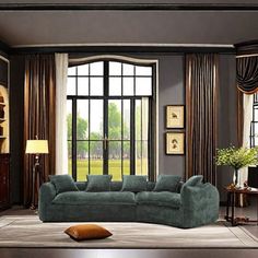 a living room filled with furniture and large windows