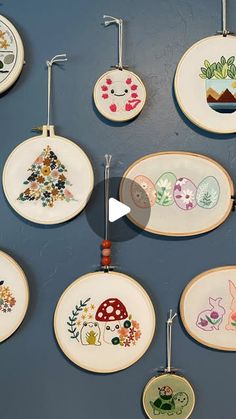 the wall is decorated with many different types of embroiderys on plates and hanging from hooks