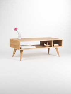 a wooden table with a flower on it next to a yellow ribbon that says 10 % off